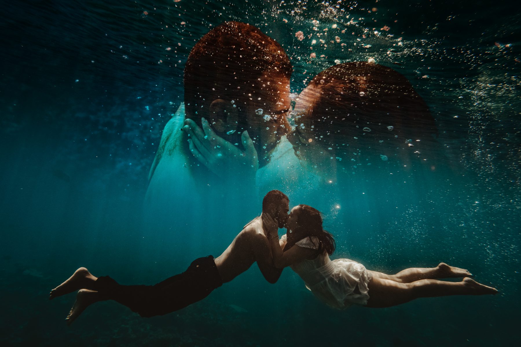 Couple kissing underwater