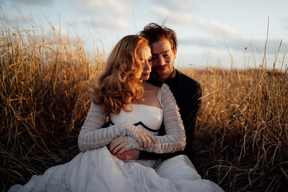 Wedding couple sitting in the grass