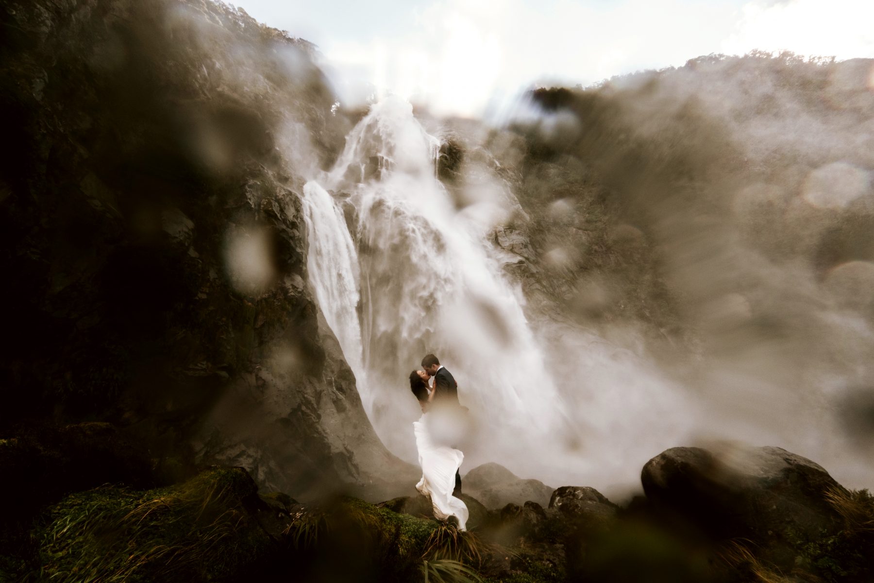 Wedding couple in front of a waterfall